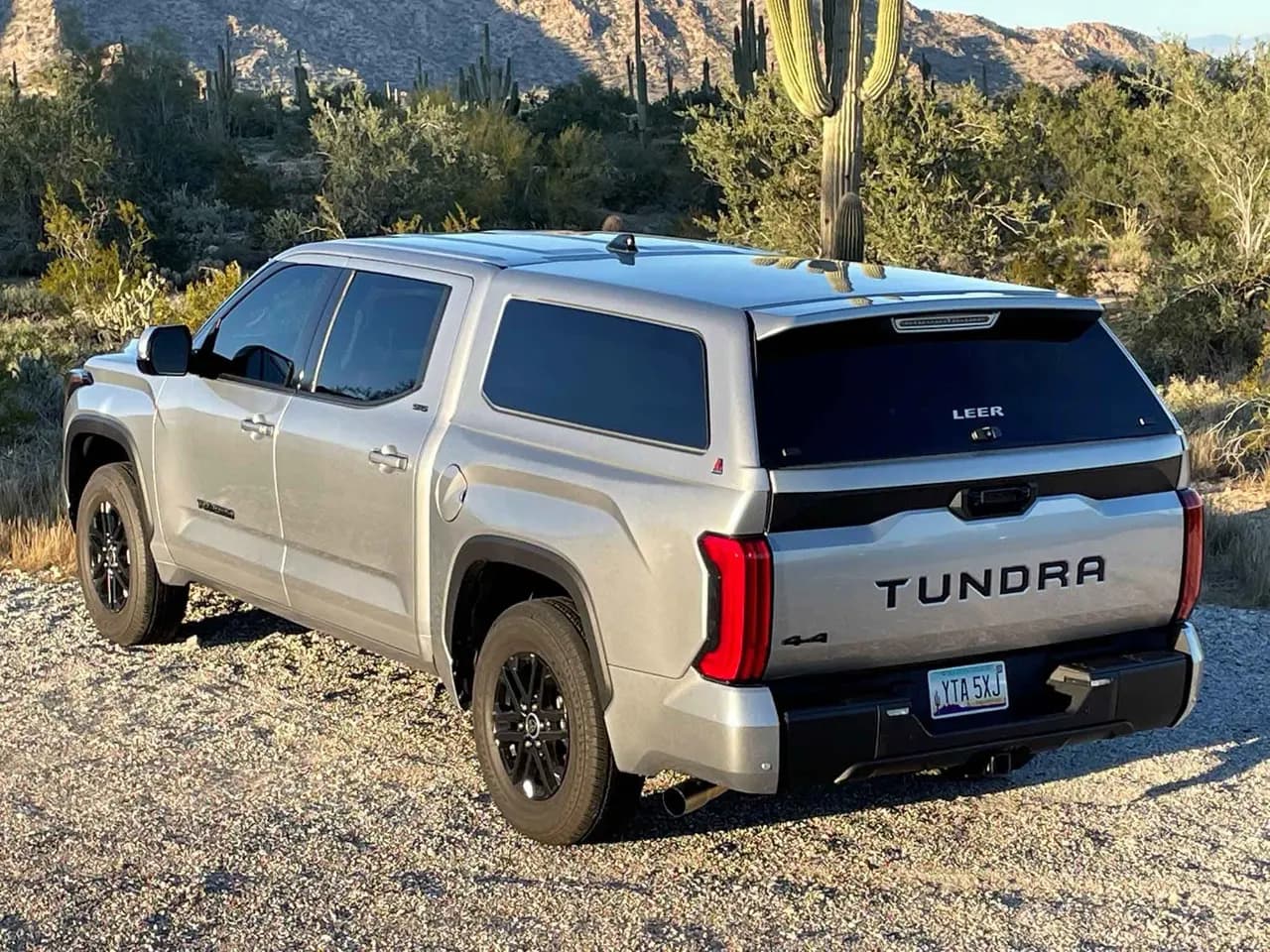Silver Toyota Tundra fitted with a LEER fiberglass truck cap