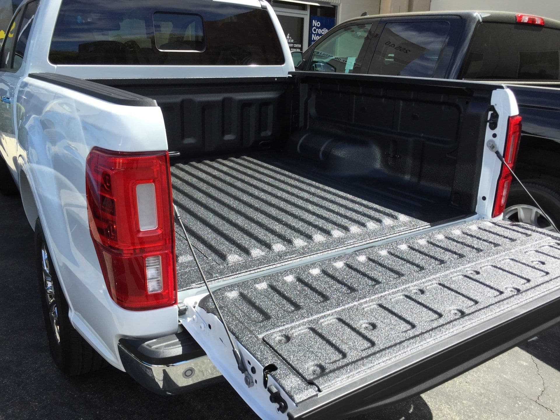 Ford Ranger with a freshly sprayed bed liner and the tailgate down, outside the Kearny Mesa shop