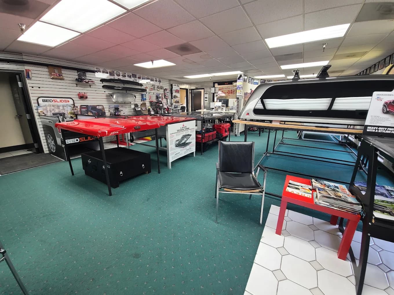 Showroom floor with BedSlide, LEER tonneau and truck cap displays on stands