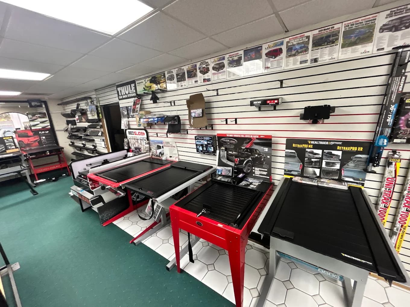Showroom with retractable and folding tonneau covers on display stands